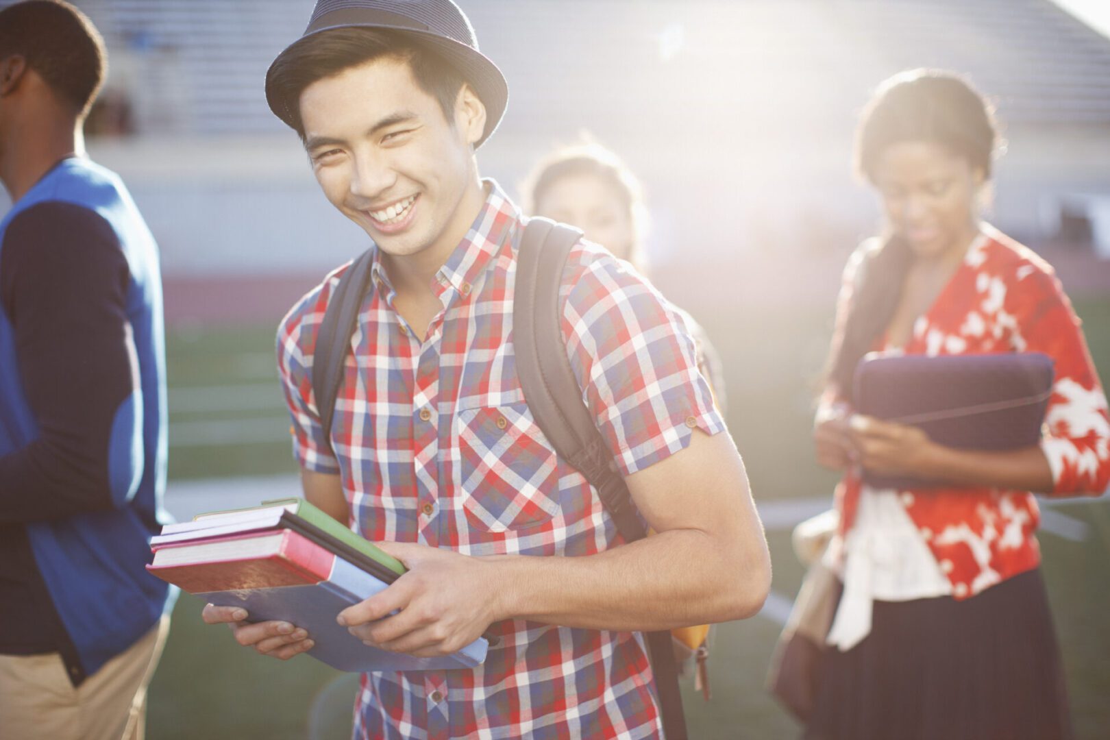 Student carrying books outdoors
