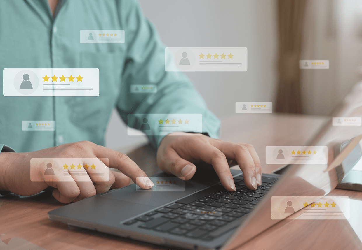 Hands on keyboard with floating review icons