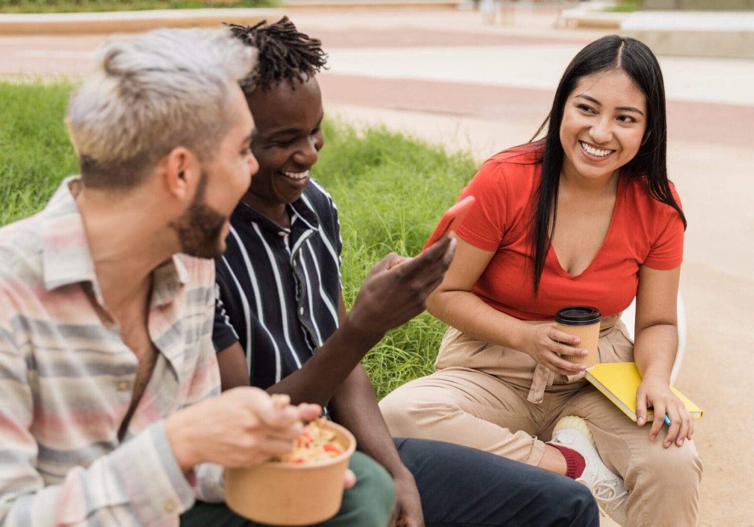 Diverse people having fun eating take away food outdoor in the city - Focus on asian girl face