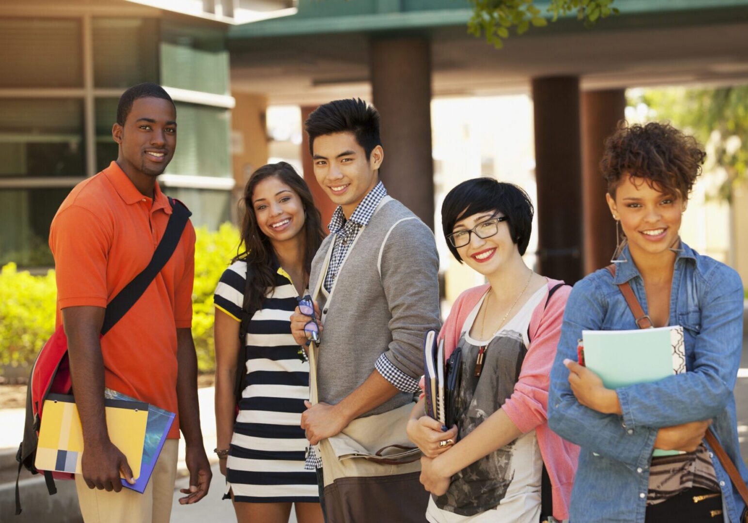 Smiling students standing together outdoors
