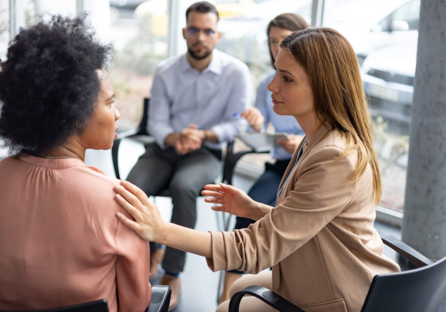 A business team shows empathy and support within an office