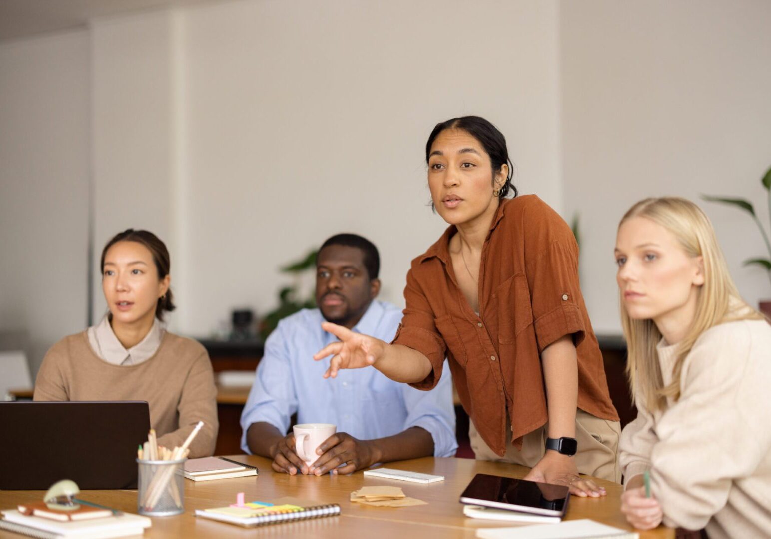 Group of diverse business people discussing ideas and sharing thoughts during a corporate meeting in a modern office